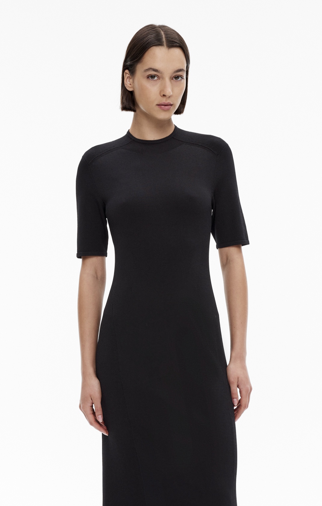 Woman in black short sleeve knit dress