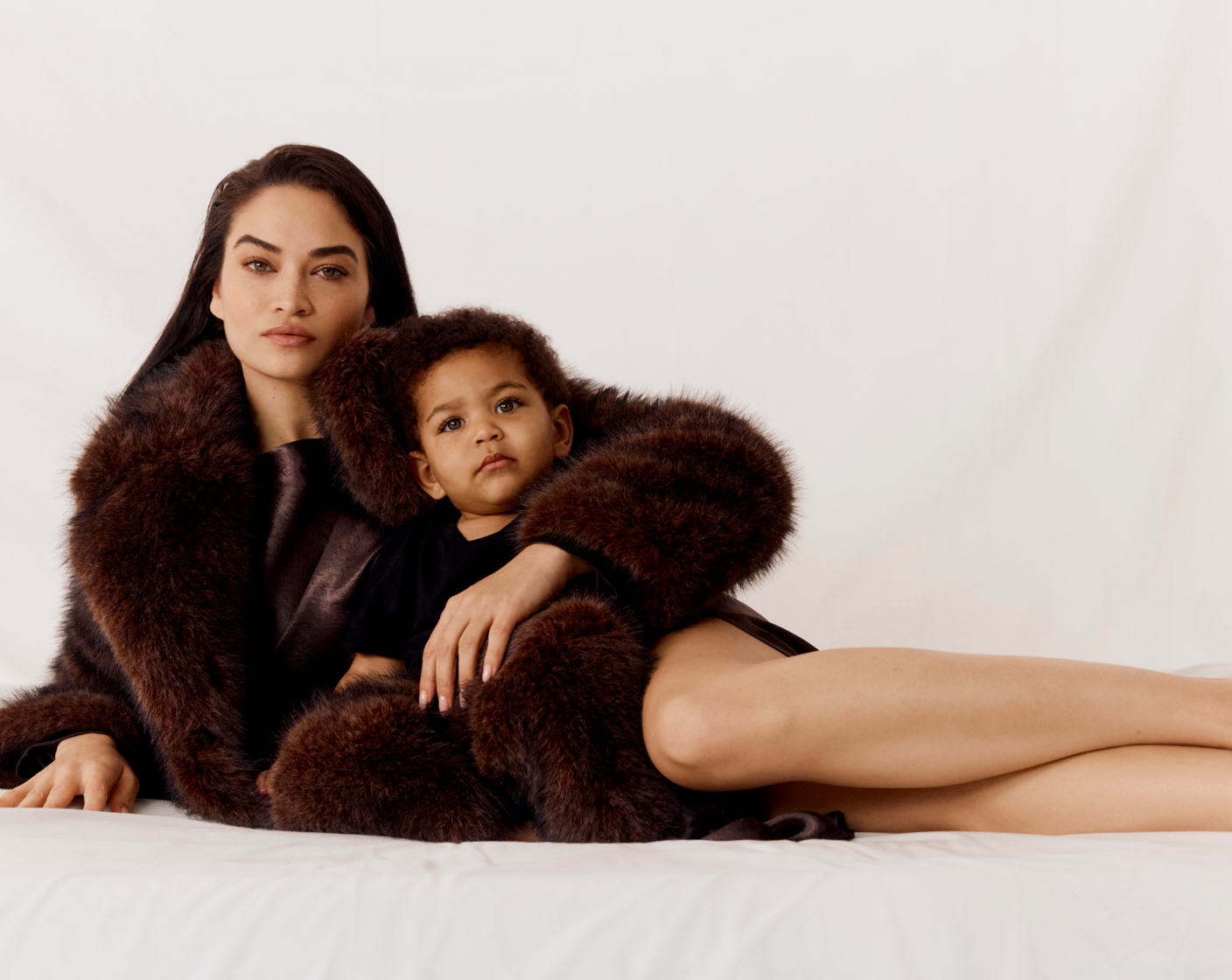 Shanina in faux fur jacket, and raisin acetate long sleeve midi dress