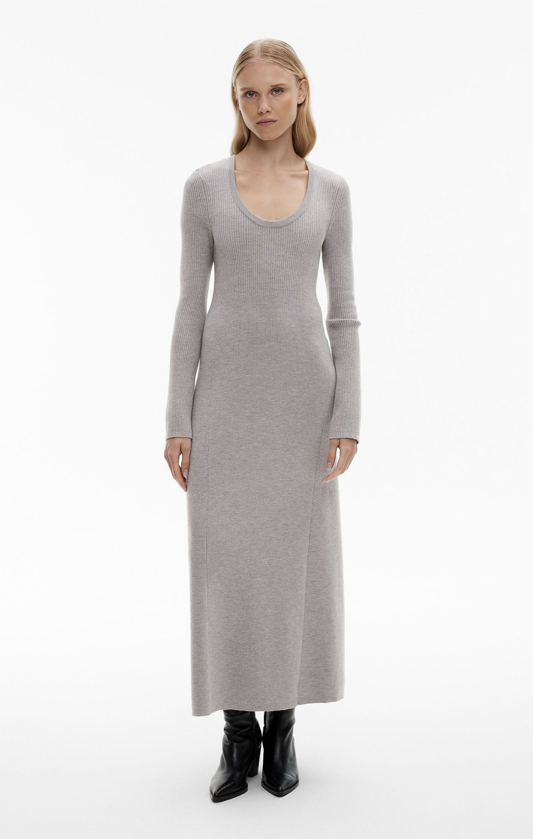 Woman in grey long sleeve knit dress and black boots