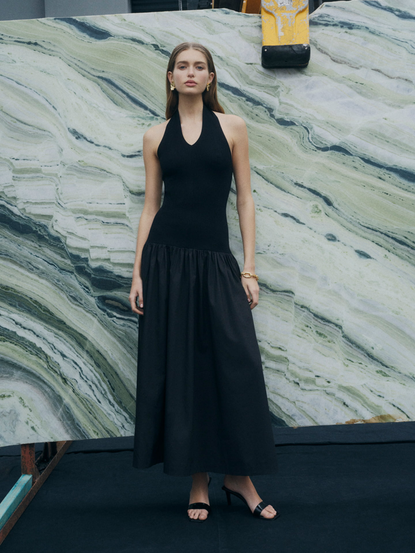 Woman in black halter maxi dress and black heels