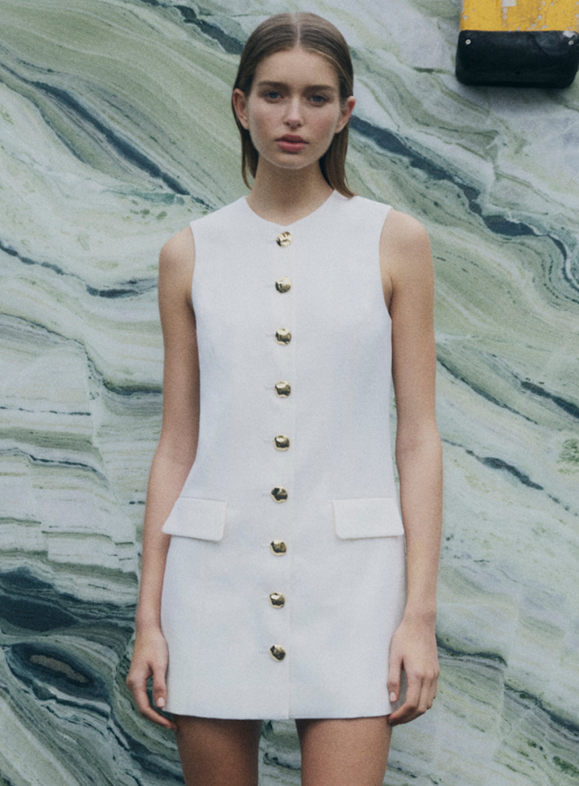 Woman in white button detail dress and white harper weave heel