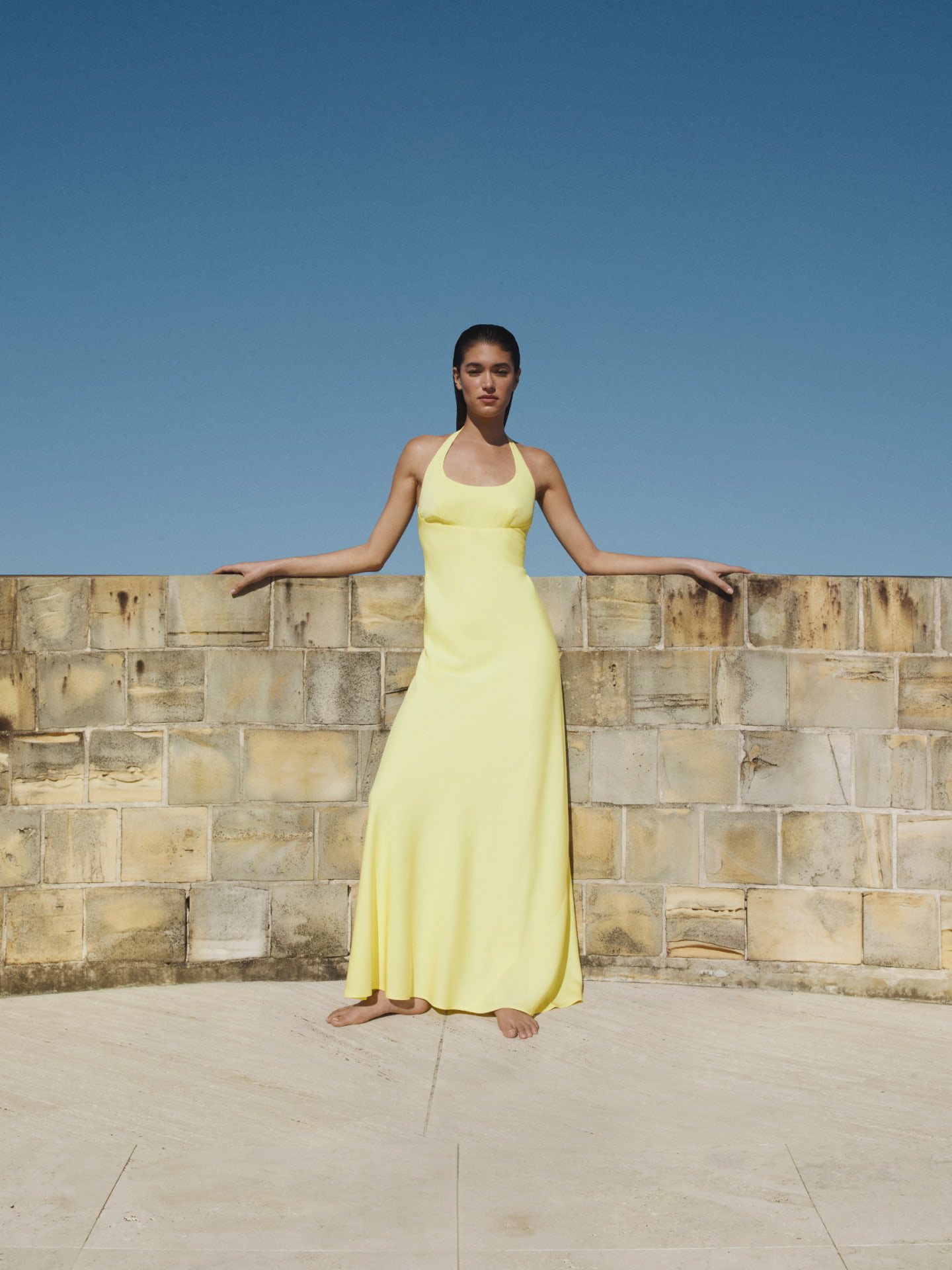 Woman in black halter maxi dress and black heels