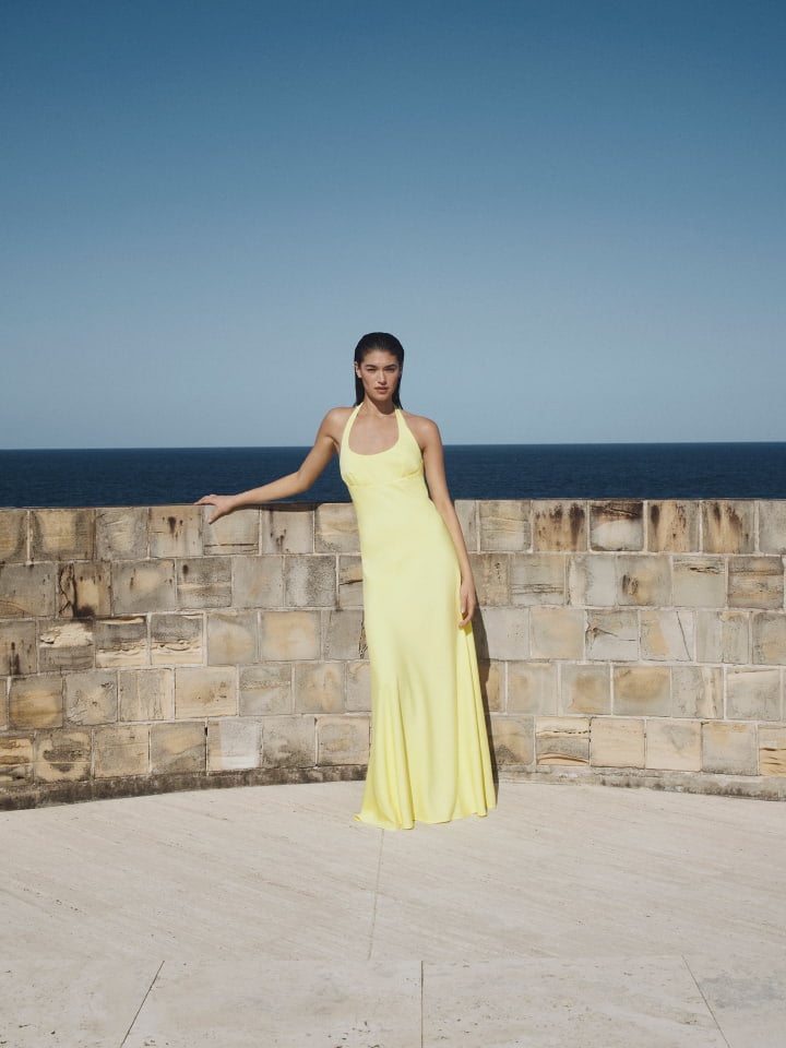 Woman in black halter maxi dress and black heels