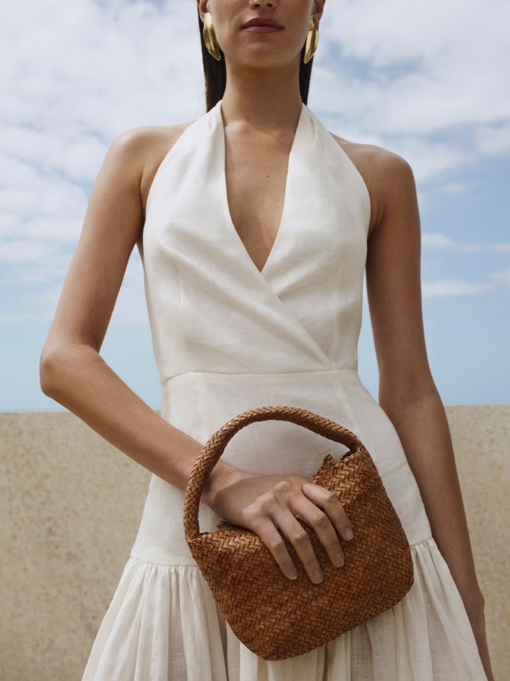 Woman in white utility pocket shirt and white linen bubble skirt
